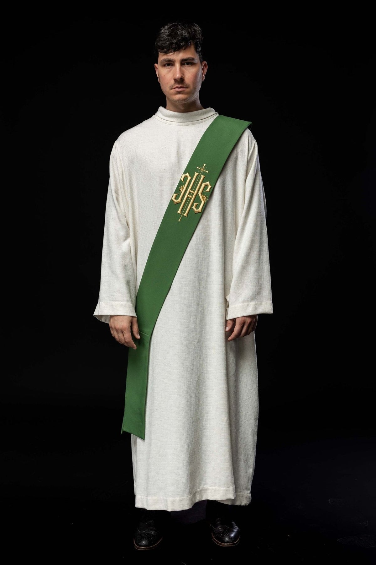 Green deacon stole worn in full front view with gold IHS and cross embroidery