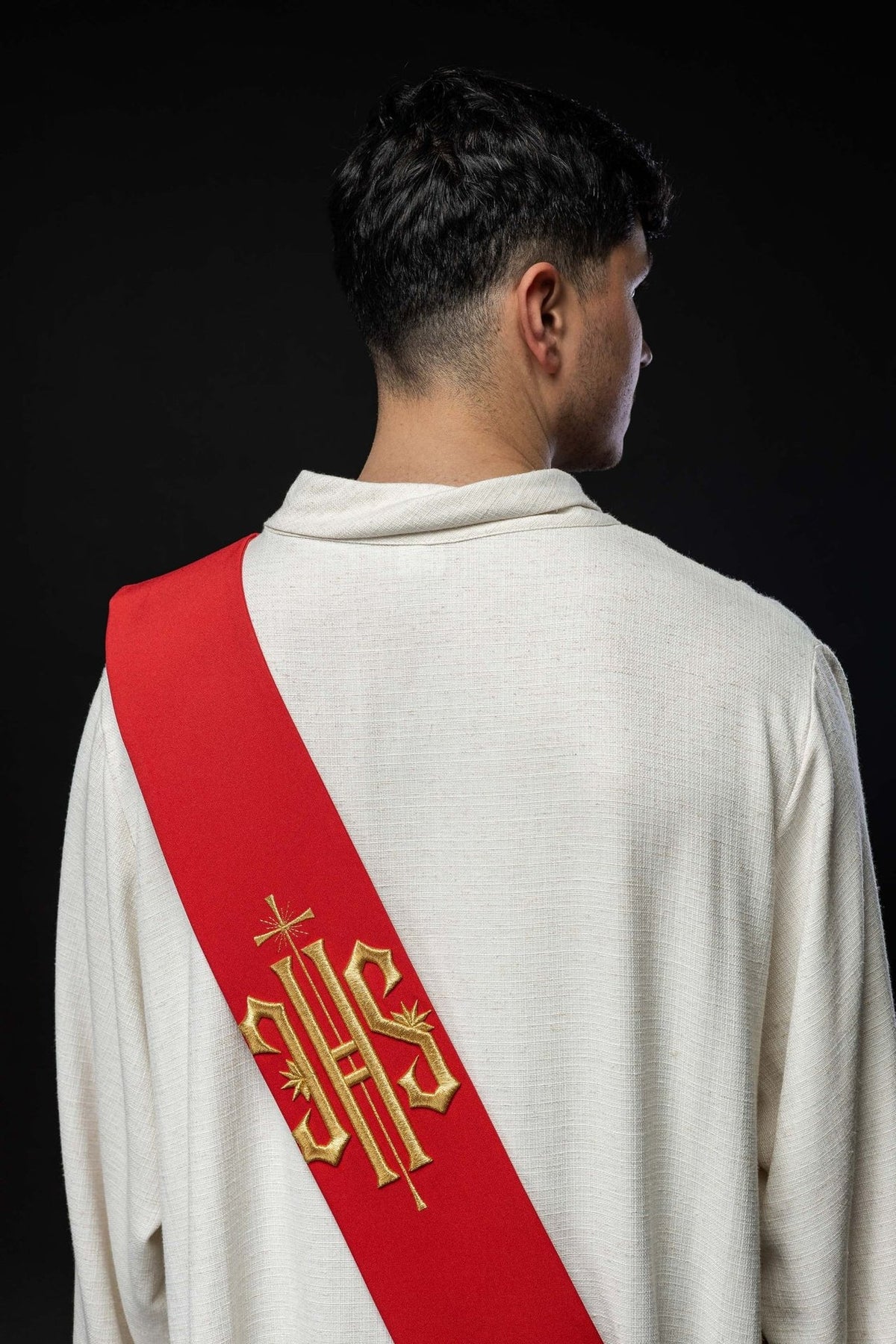 Red deacon stole worn from the back with gold IHS embroidery