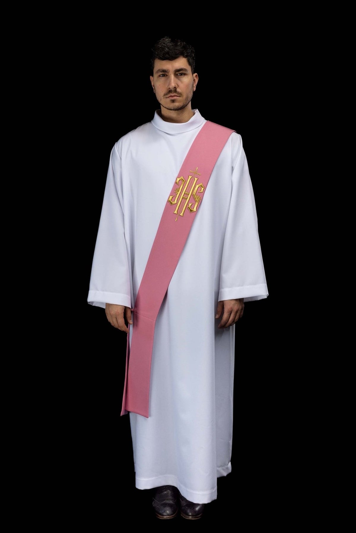 Rose deacon stole worn full-length from the front with gold IHS embroidery and cross