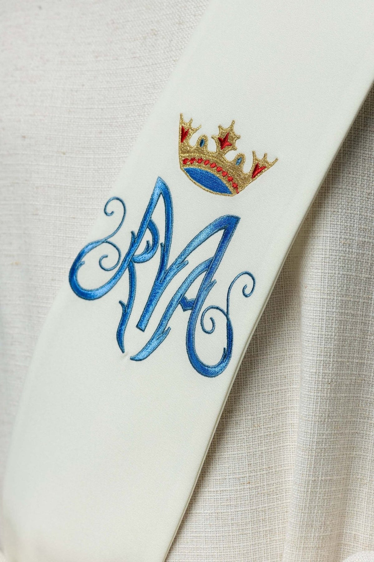 Marian deacon stole close-up with embroidered blue Marian symbol and gold, red, and blue crown
