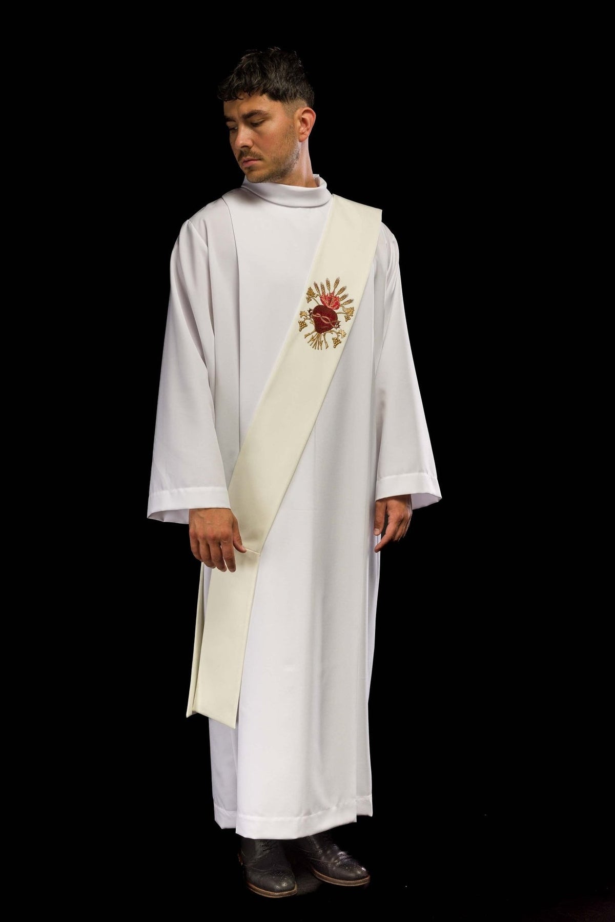 Ivory deacon stole worn from the front at an angle, showing the embroidered Sacred Heart of Jesus