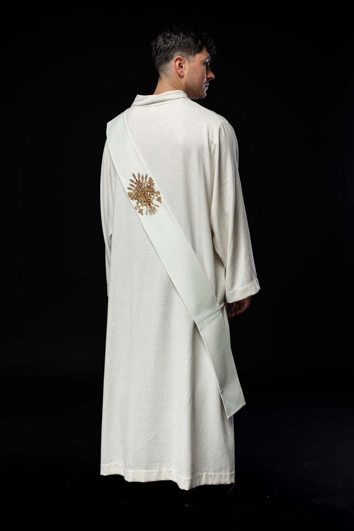 White deacon stole worn from the back, showing the embroidered grapes, wheat and cross