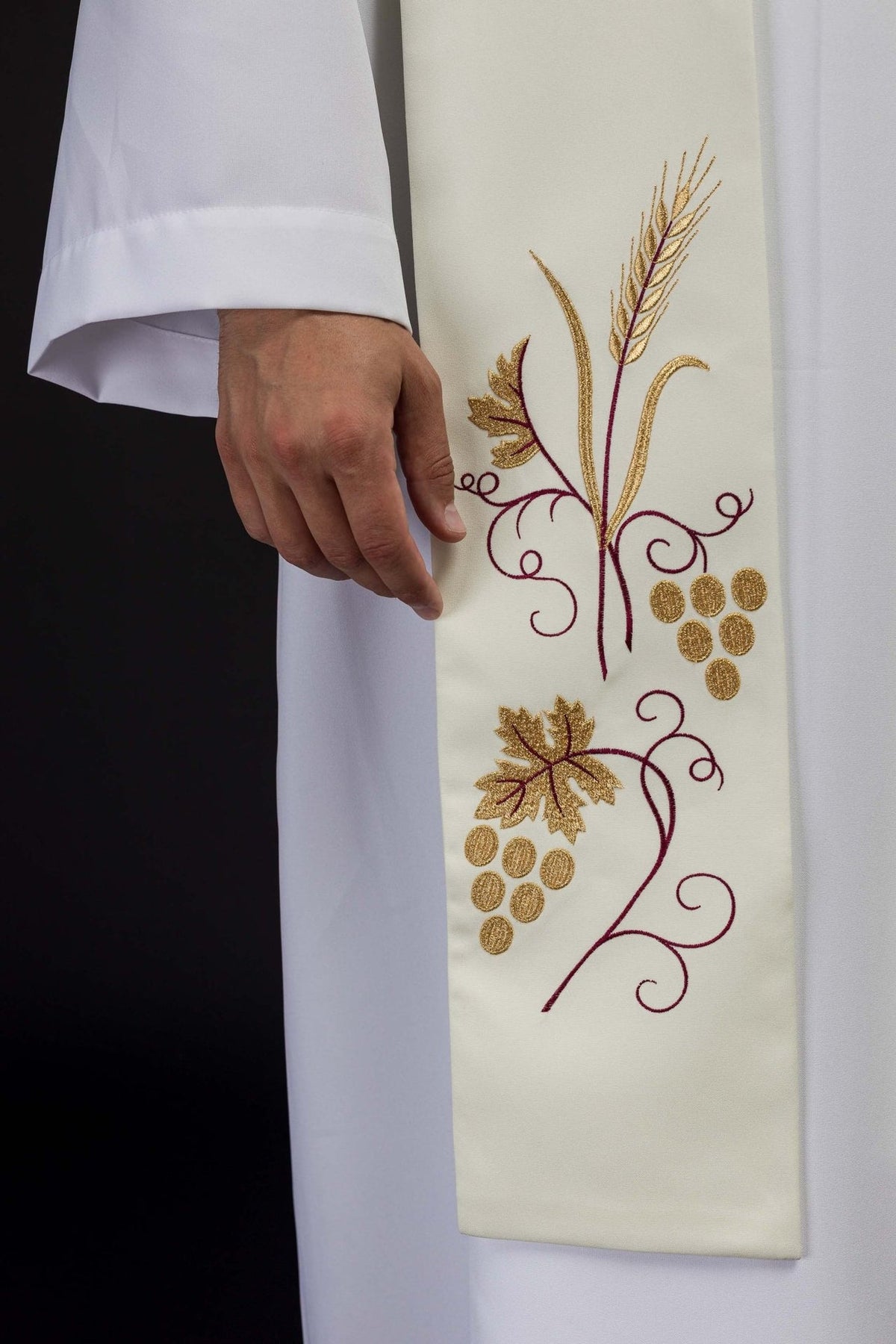 Ecru stole close-up showing embroidered grapes, wheat and burgundy vines