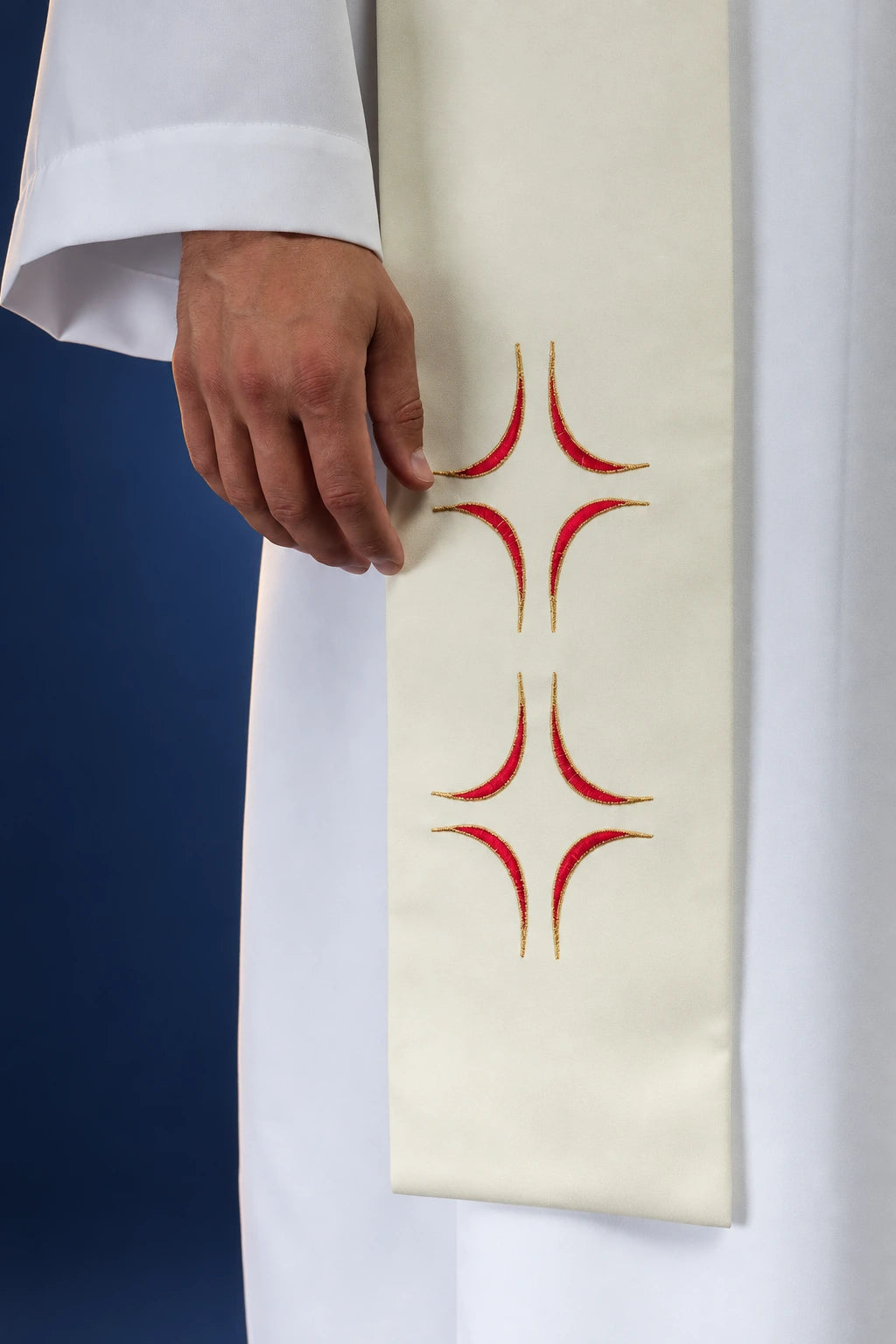 Stole close-up showing repeated red and gold cross embroidery