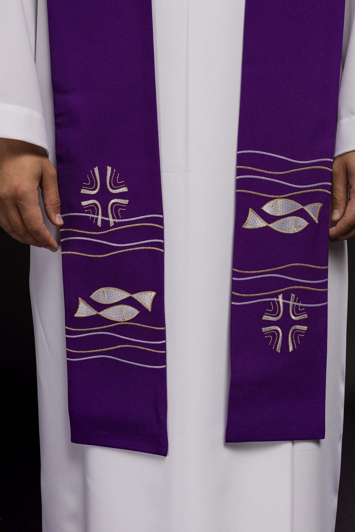 Purple priest stole close-up showing embroidered fish, crosses and gold and silver wave embroidery