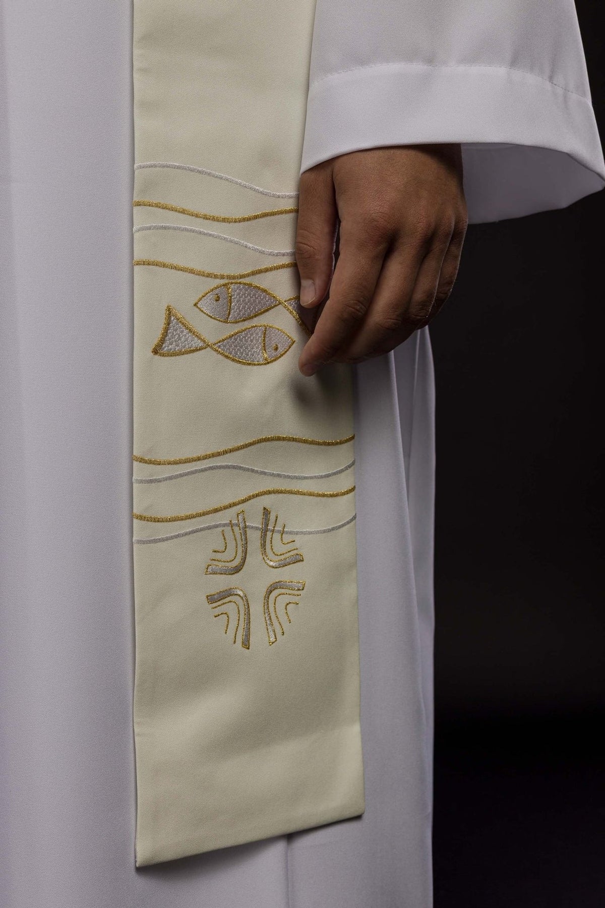 Ecru priest stole close-up showing embroidered fish motifs and gold wavy lines