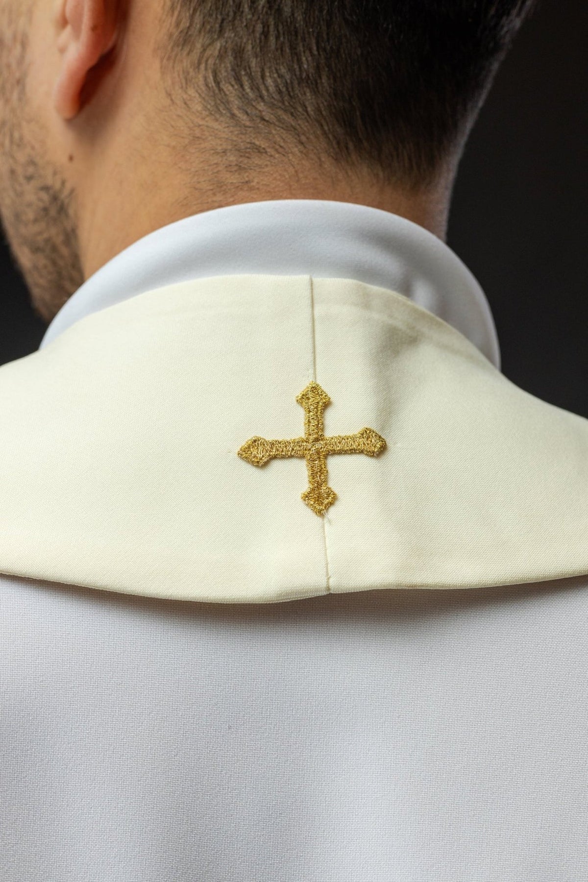 Ecru stole close-up showing gold embroidered cross motif