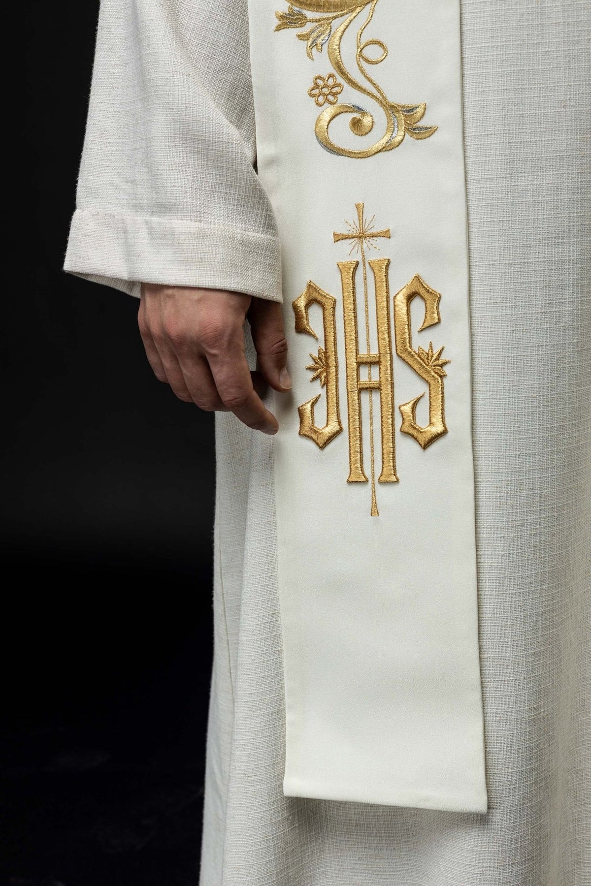 Ecru stole close-up showing gold embroidered IHS motif