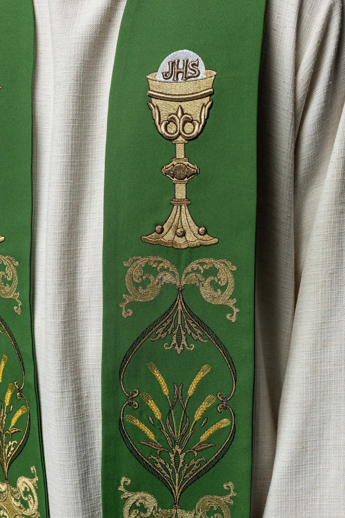 Green stole close-up showing chalice, scrollwork and floral embroidery
