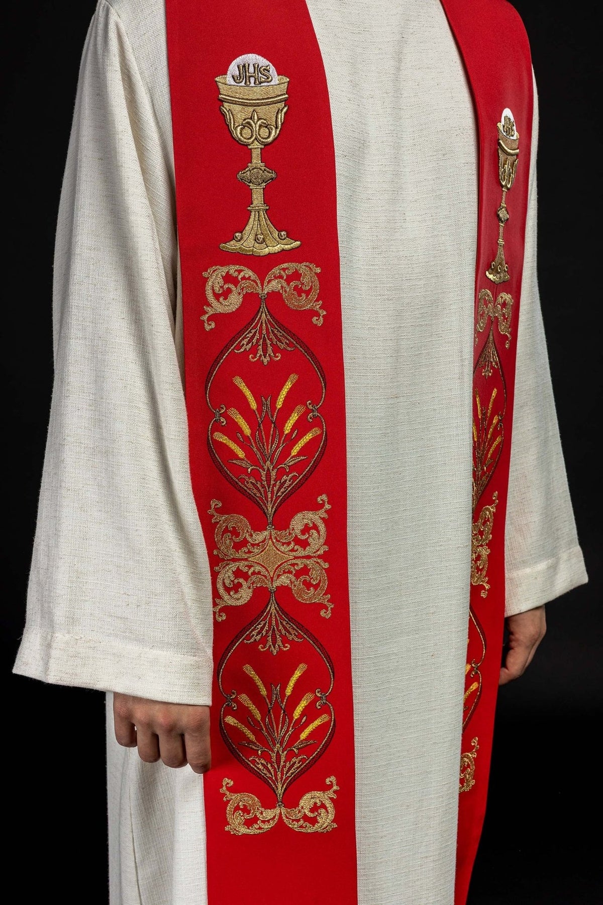 Red priest stole close-up with gold chalice and IHS embroidery