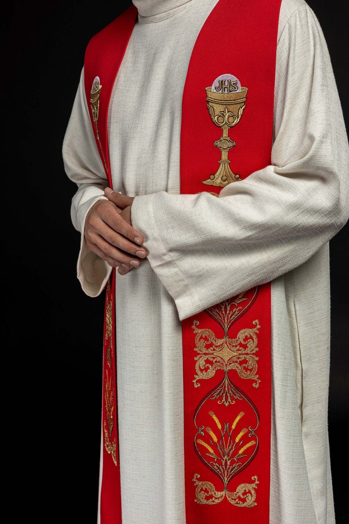 Red priest stole worn at an angle, showing chalice and floral embroidery