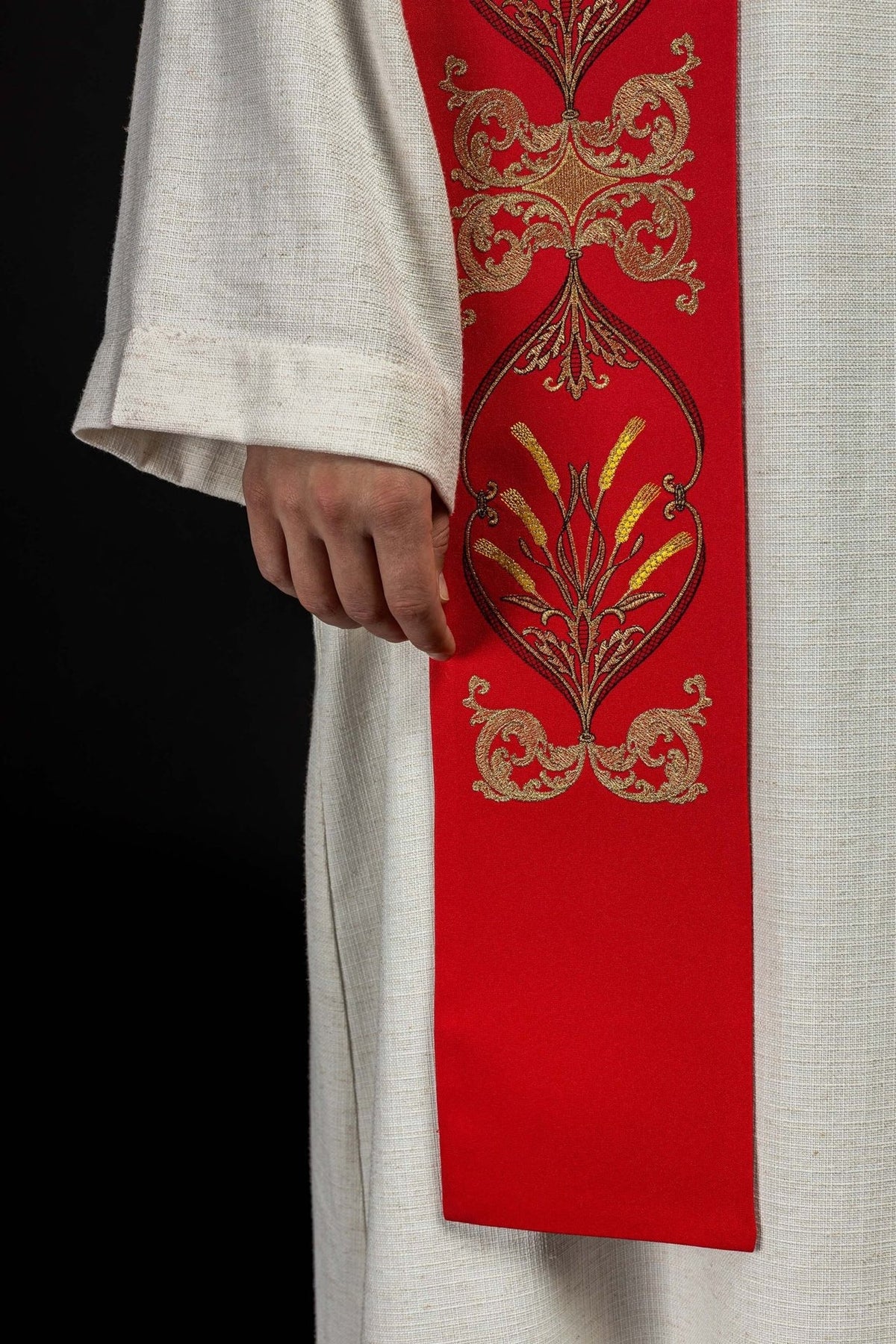 Red stole close-up showing gold floral embroidery