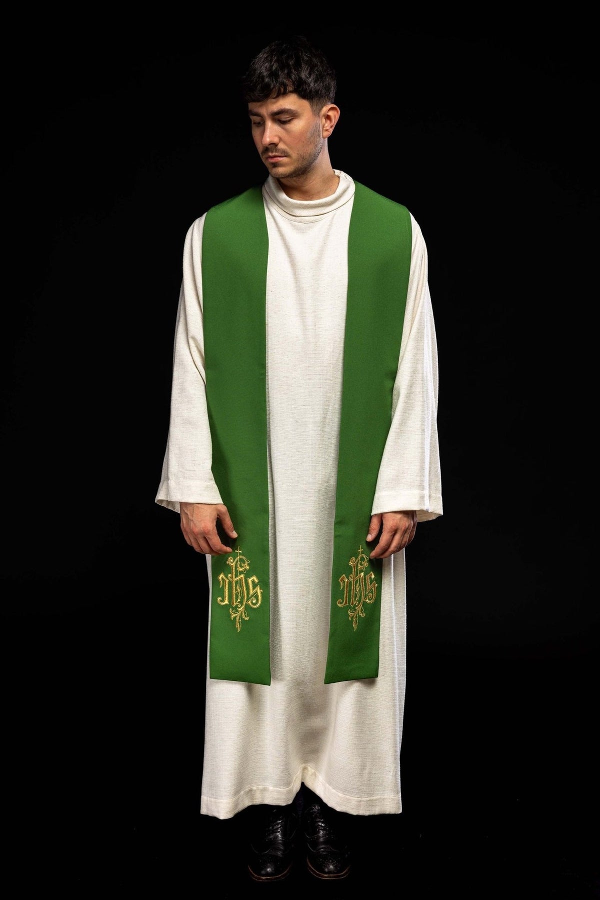 Green stole front view worn, showing its full length and matching gold IHS embroidery