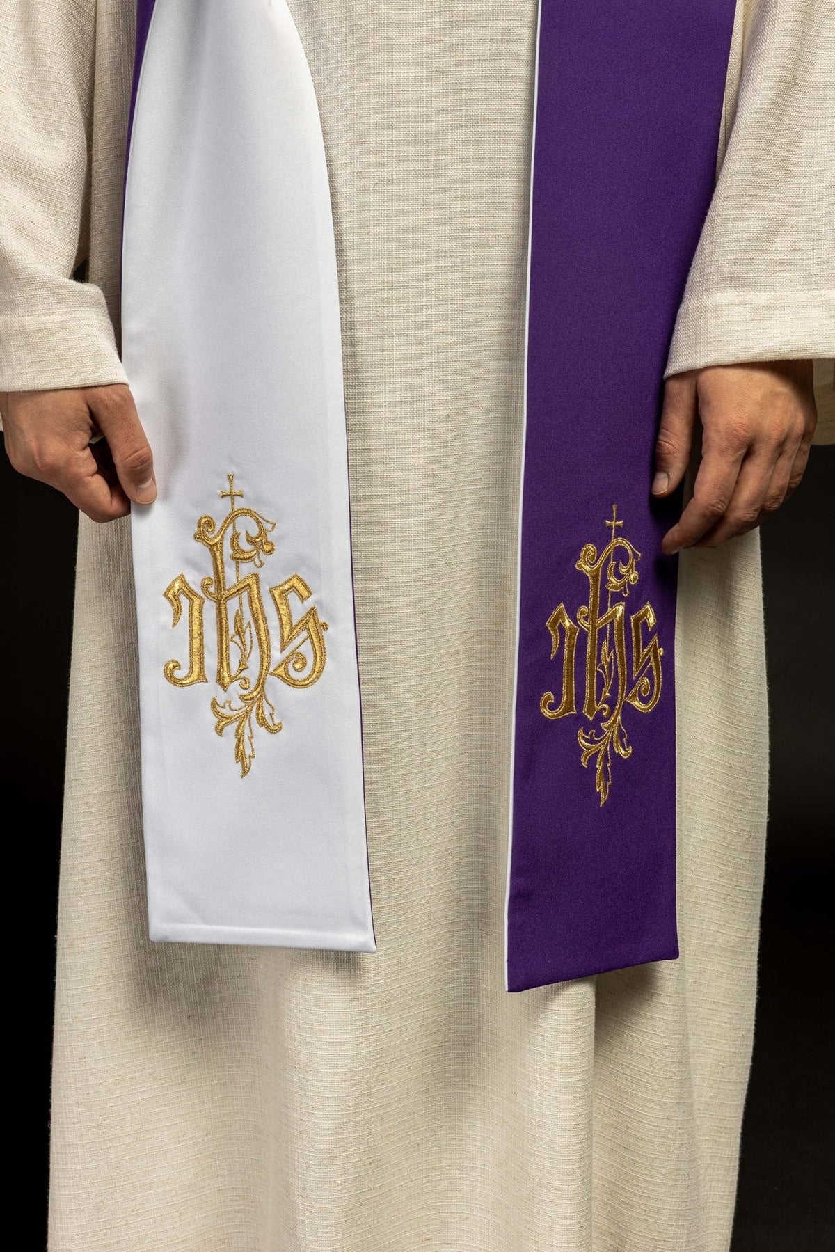 Reversible stole close-up showing purple and white sides with gold IHS embroidery