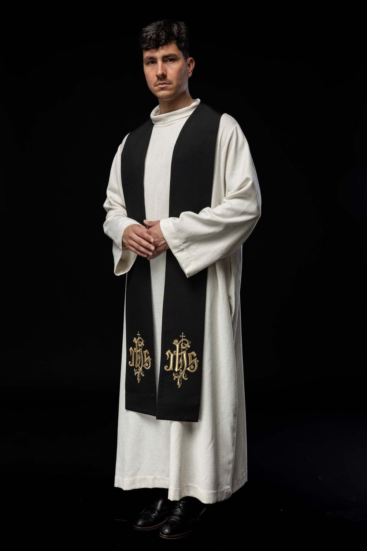 IHS stole worn at an angle, showing black fabric and gold embroidery