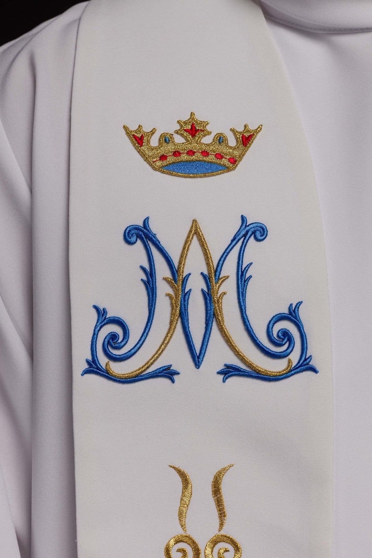 Priest stole close-up showing embroidered gold crown and blue Marian symbol
