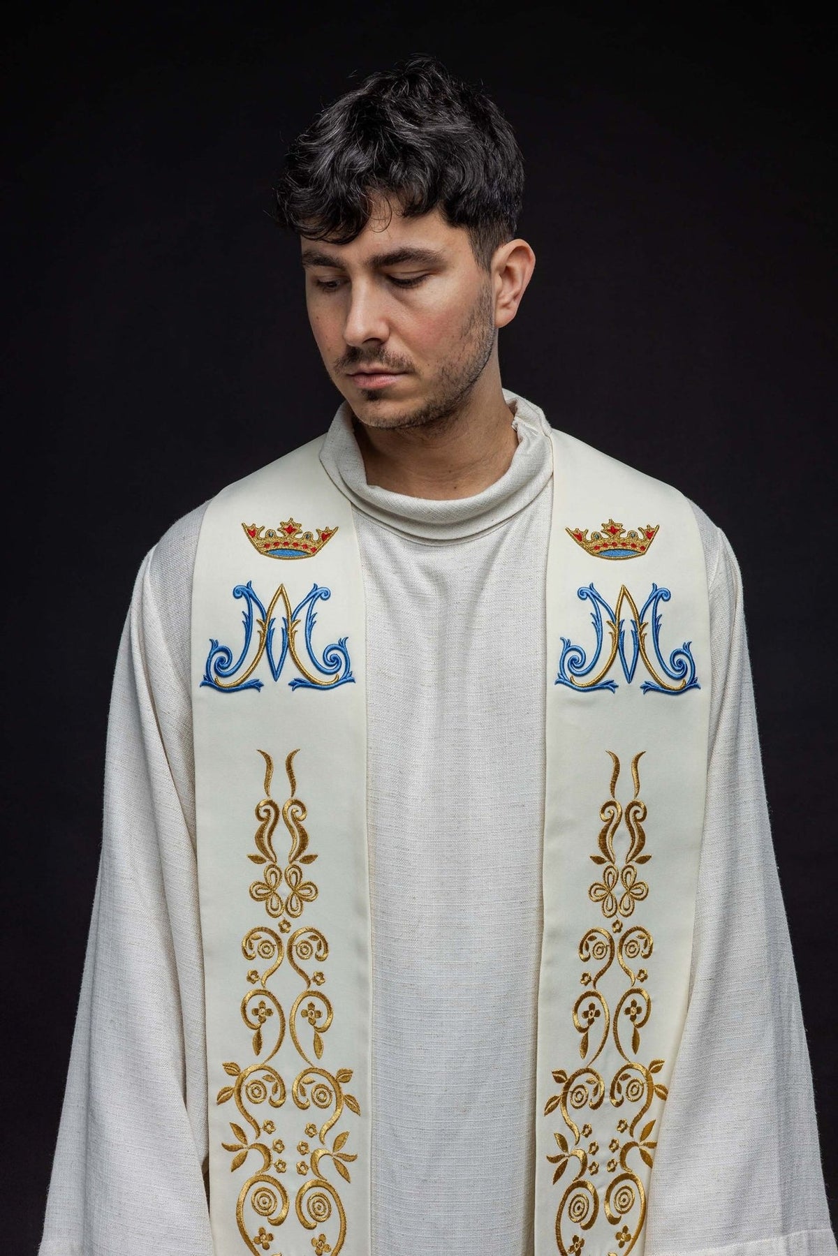 Marian ecru stole close-up showing blue Marian symbols, crowns and gold embroidered motifs