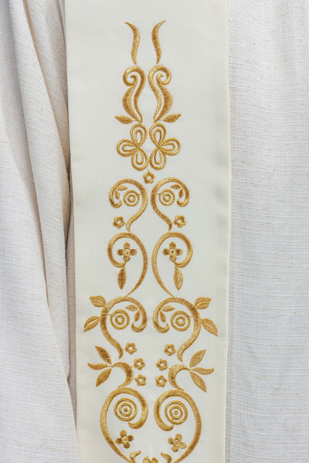 Marian ecru stole detail showing symmetrical gold embroidered floral scrollwork