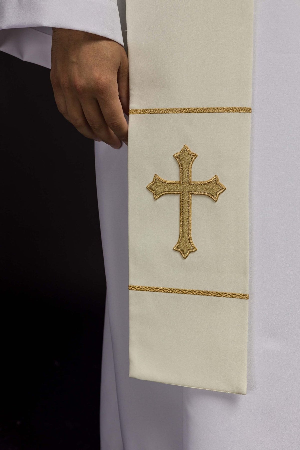 Ecru priest stole close-up showing gold cross embroidery and trim