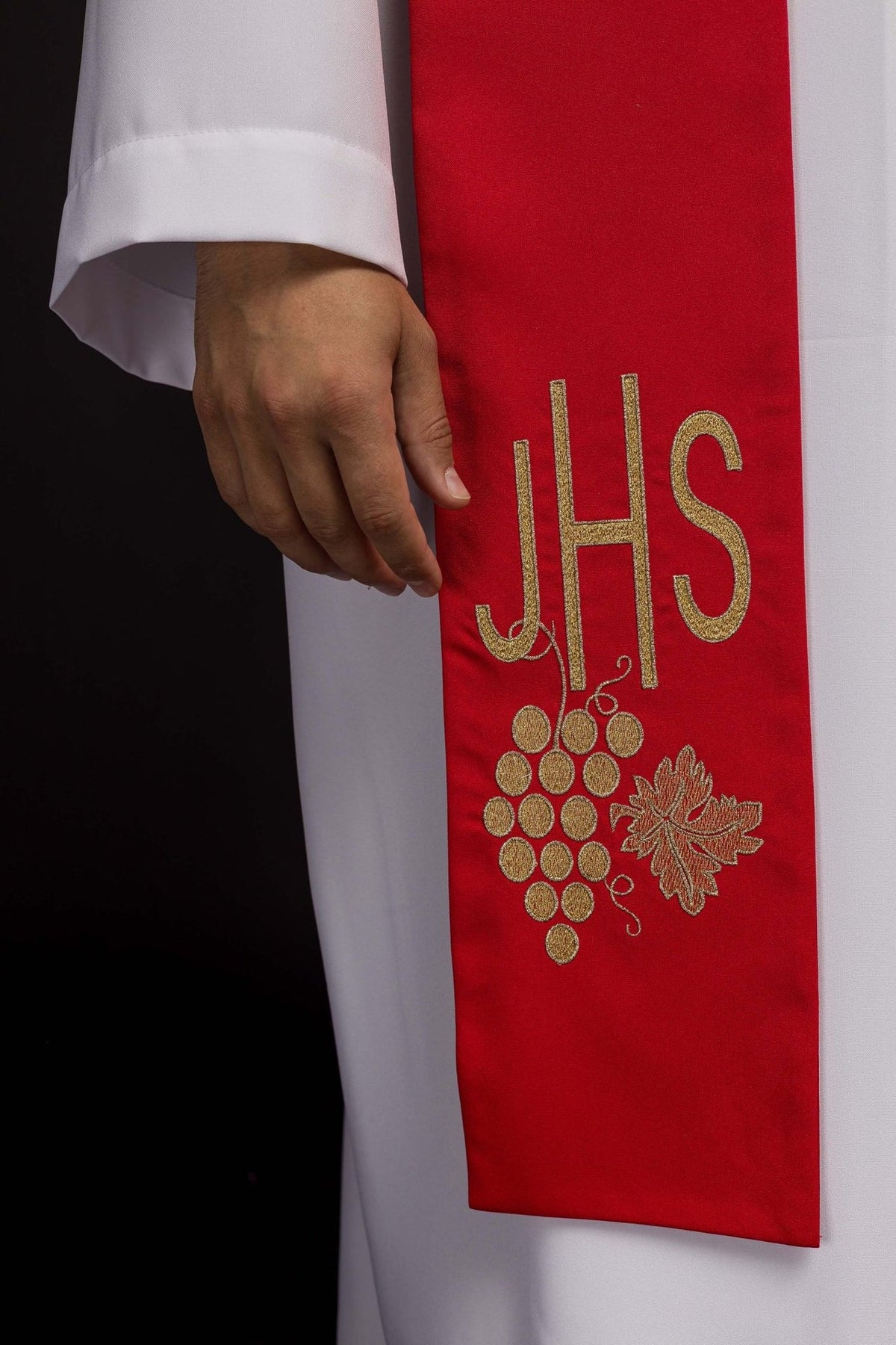 Red priest stole close-up showing embroidered IHS and grapes