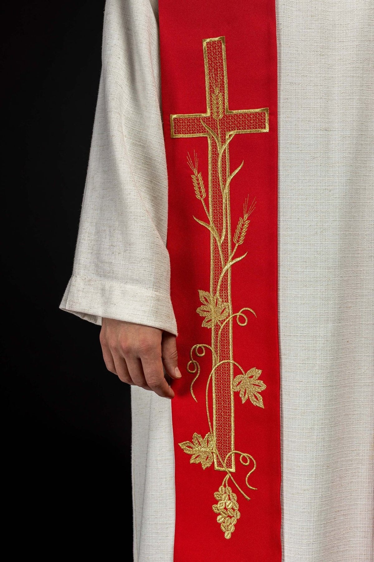 Red priest stole close-up with embroidered cross, wheat and vine details
