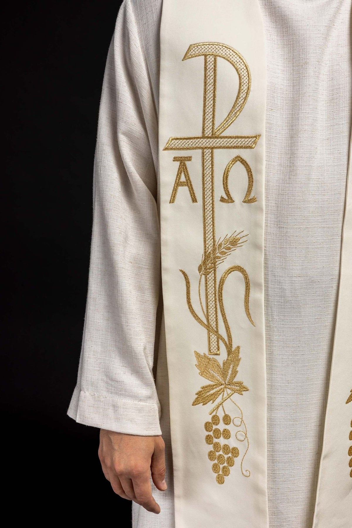 Ecru stole detail with gold embroidered cross, Alpha Omega, wheat, leaves and grapes