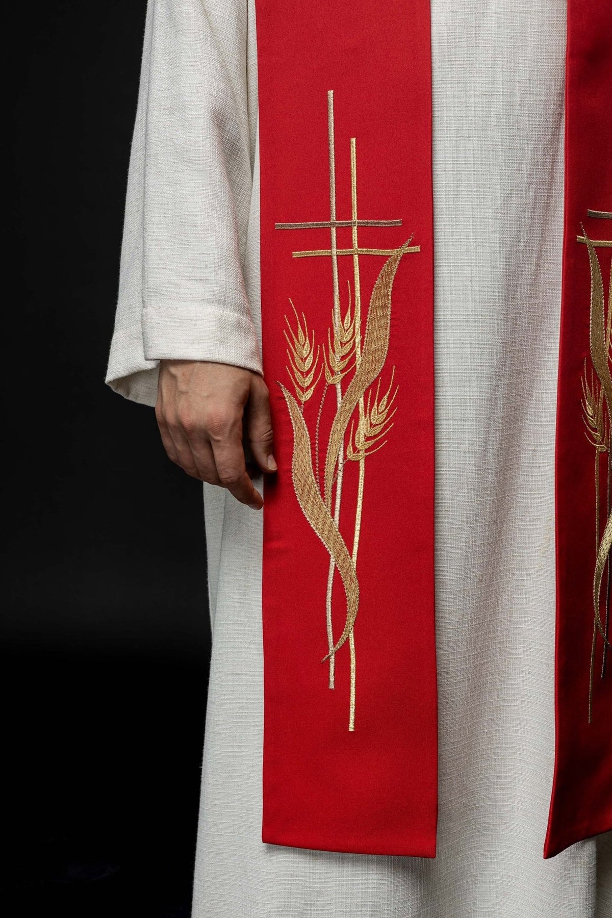 Red priest stole close-up showing gold cross and wheat embroidery
