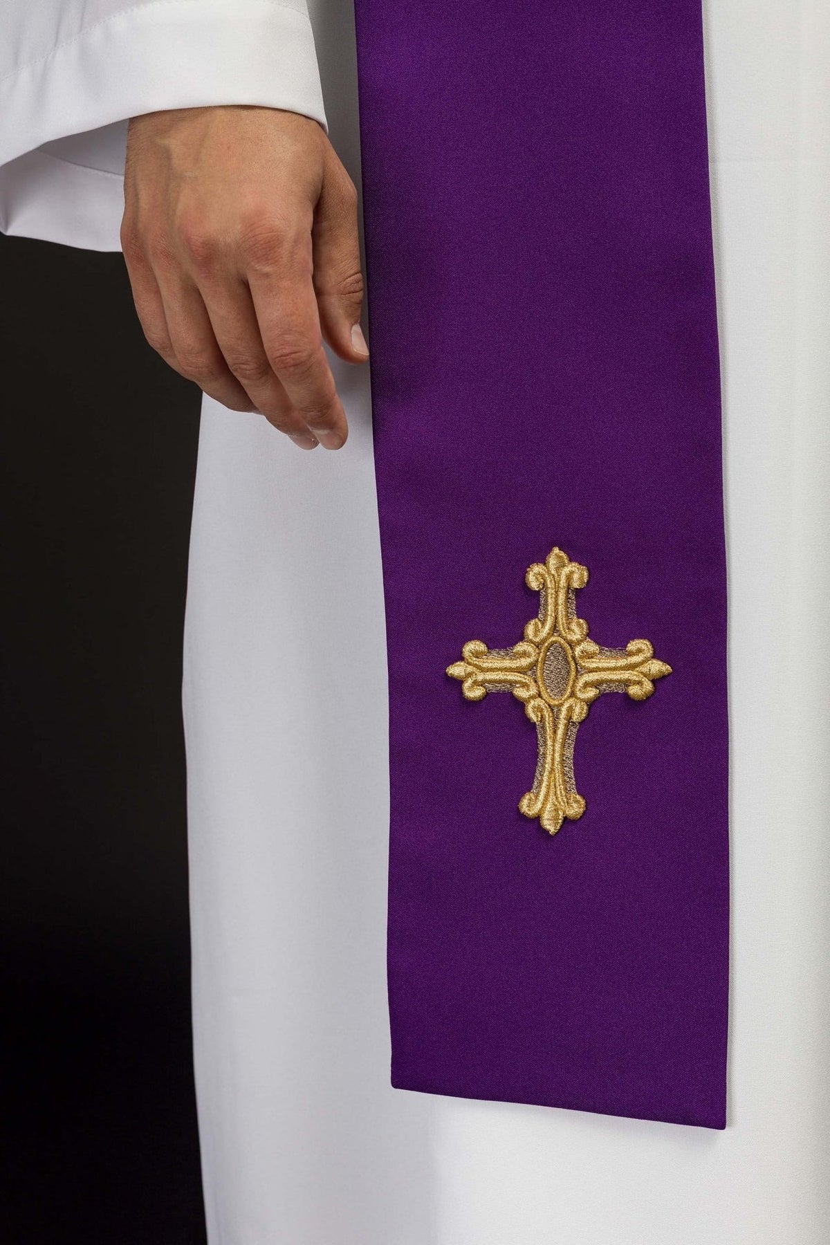 Purple priest stole close-up showing a gold embroidered cross