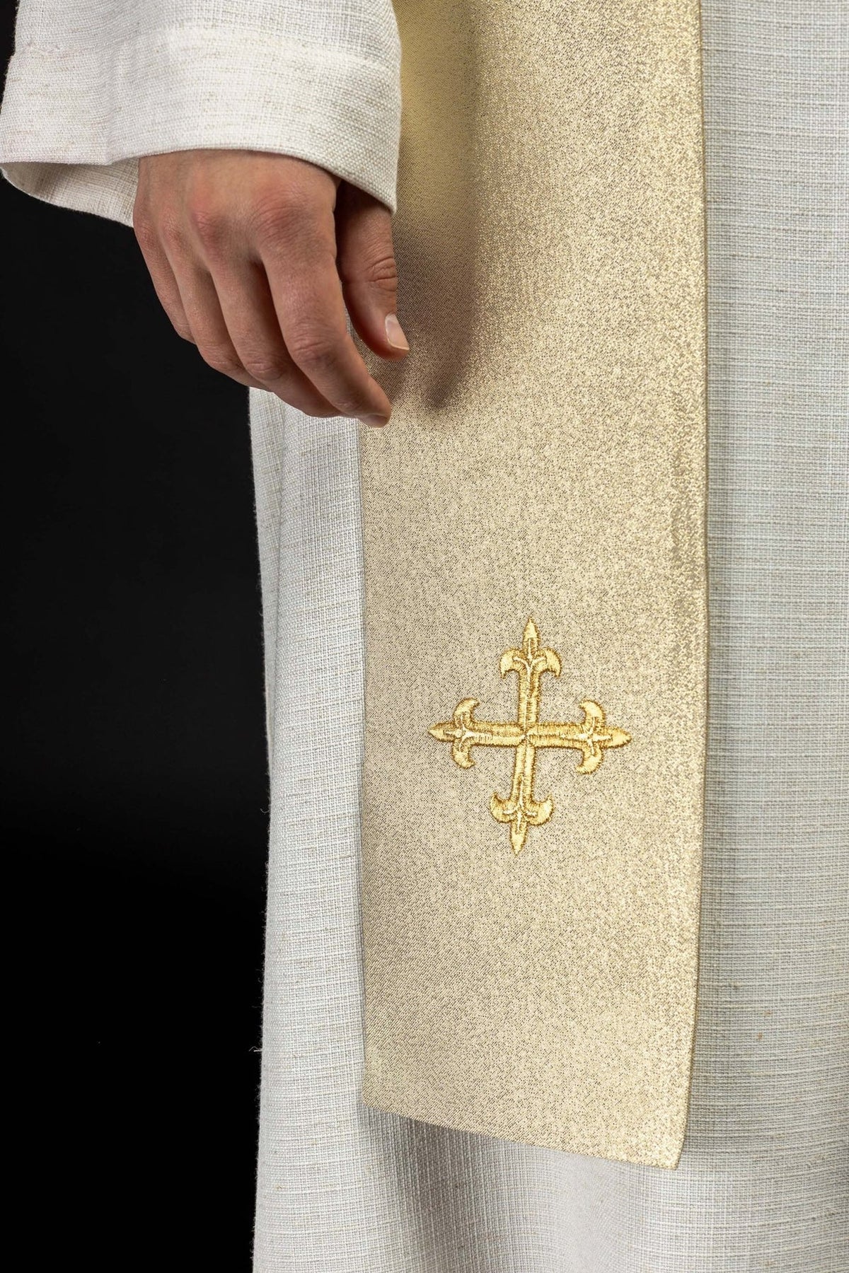 Gold stole detail showing embroidered gold cross near the lower end