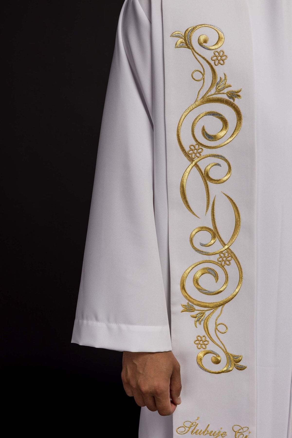White wedding stole close-up showing gold wedding rings and dove embroidery