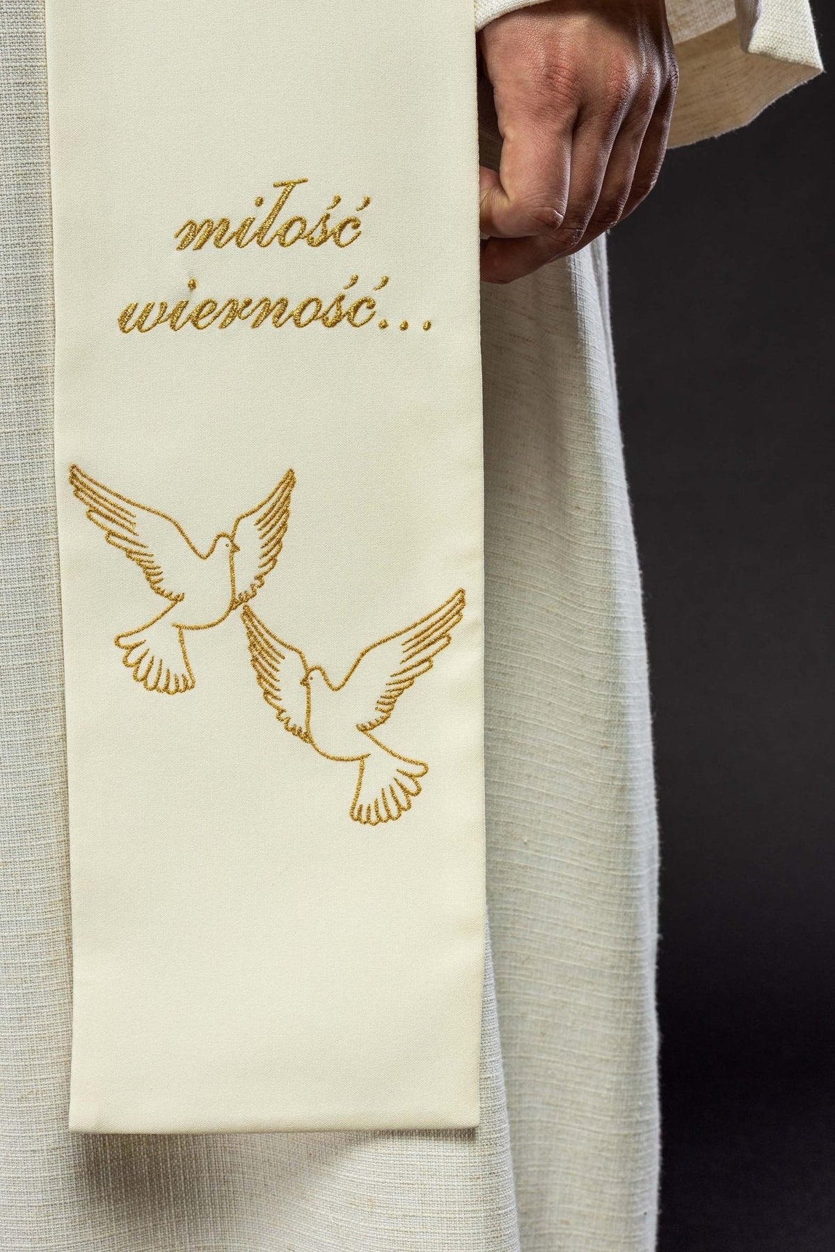 Cream wedding stole close-up with gold embroidered doves and script