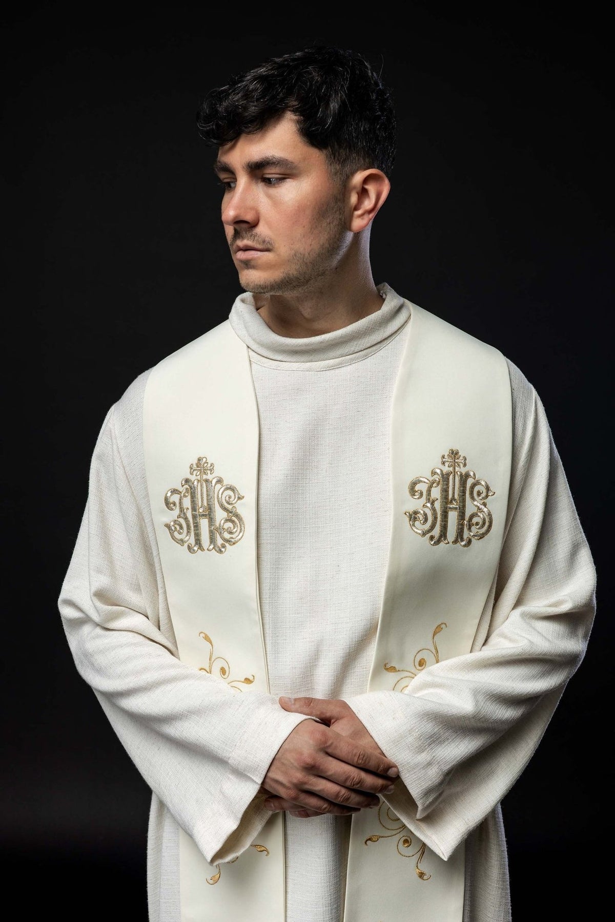 Ecru stole worn close-up, showing gold IHS embroidery and scrollwork