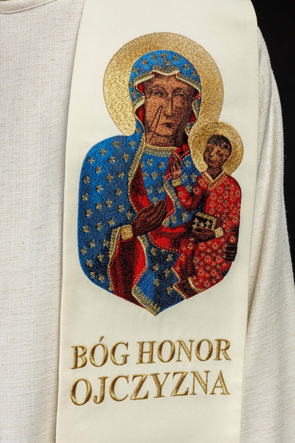 Embroidered stole close-up featuring Our Lady with Child and gold Polish inscription