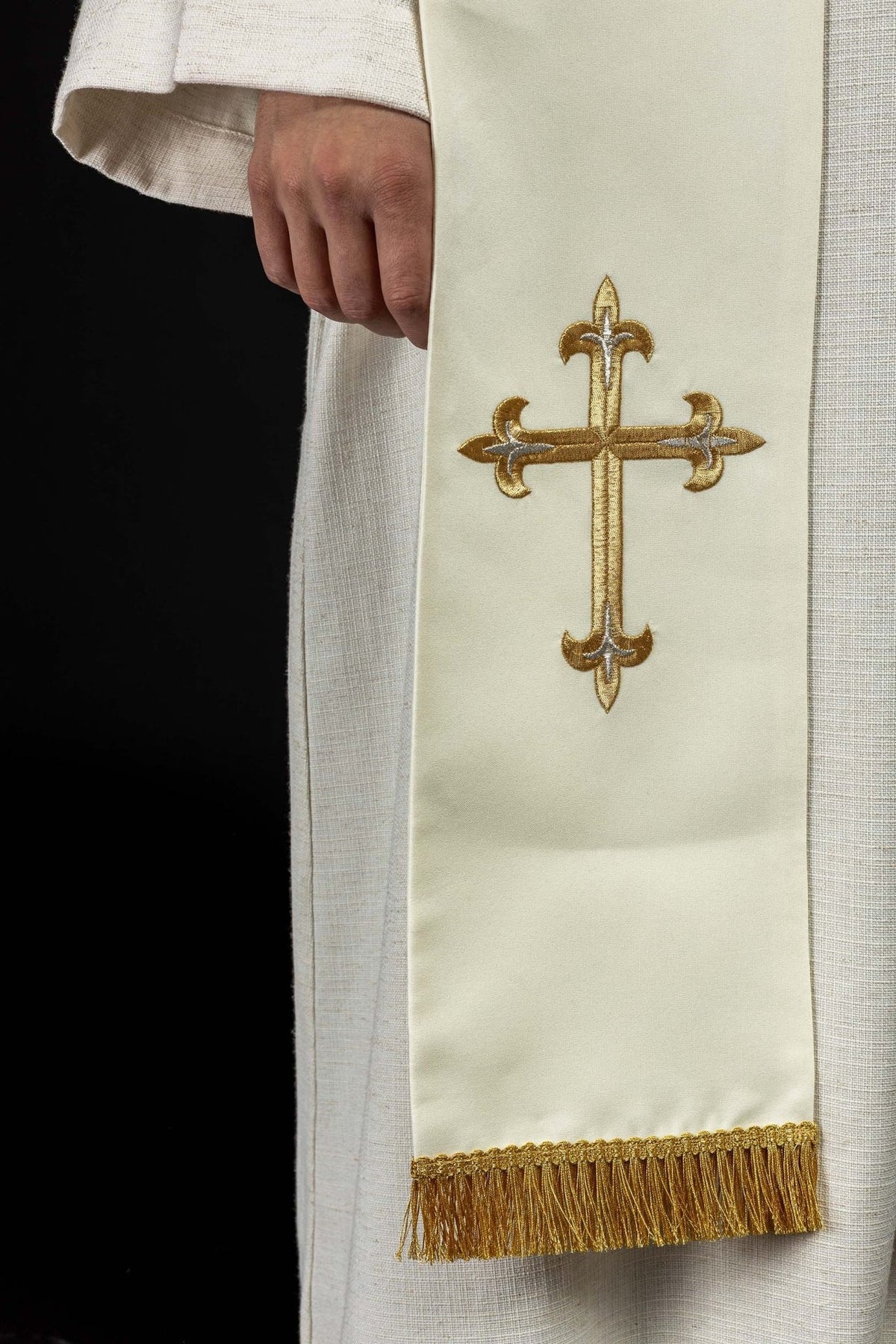 White stole detail with embroidered gold cross and gold fringe