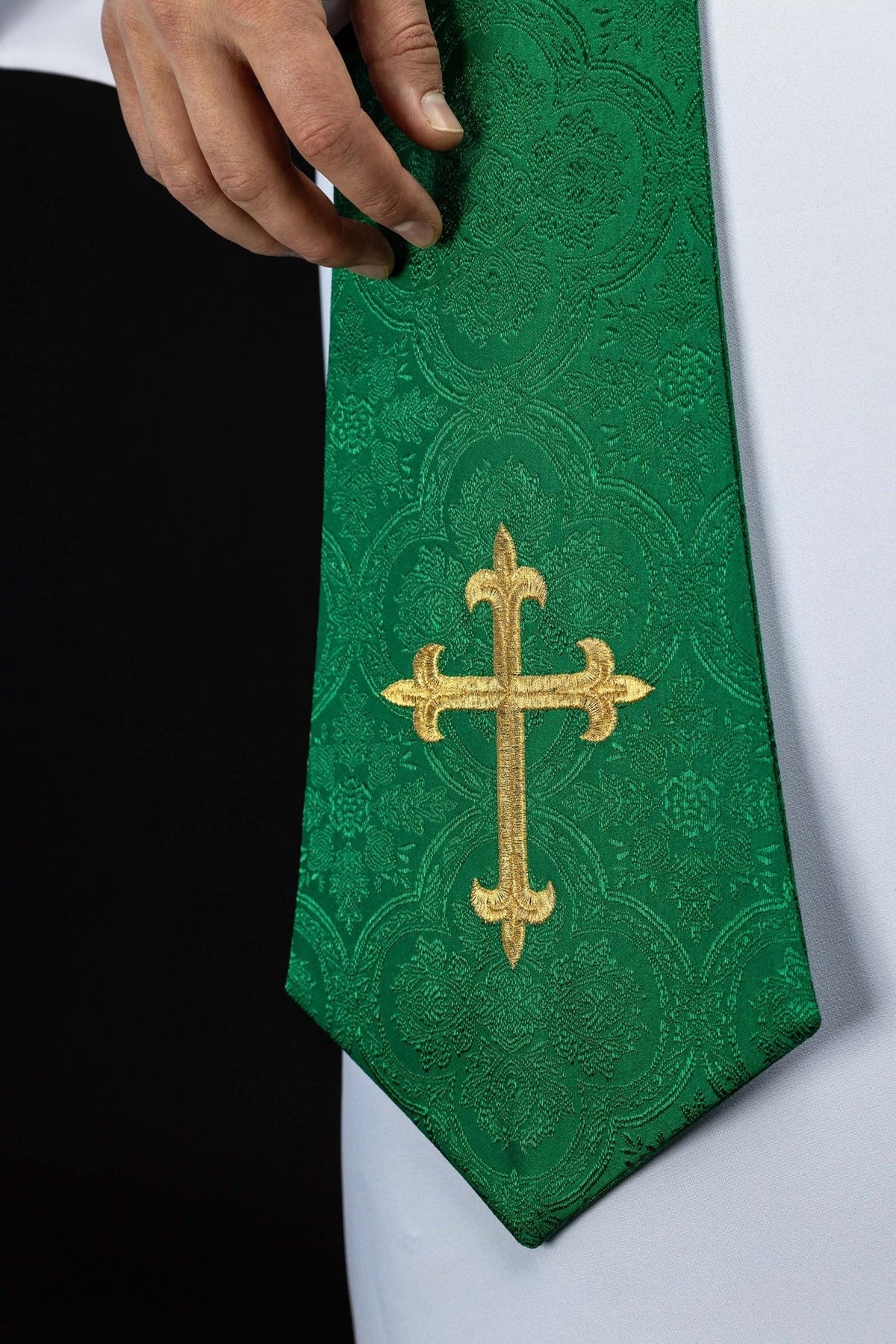 Green jacquard priest stole close-up with embroidered gold cross and floral motifs