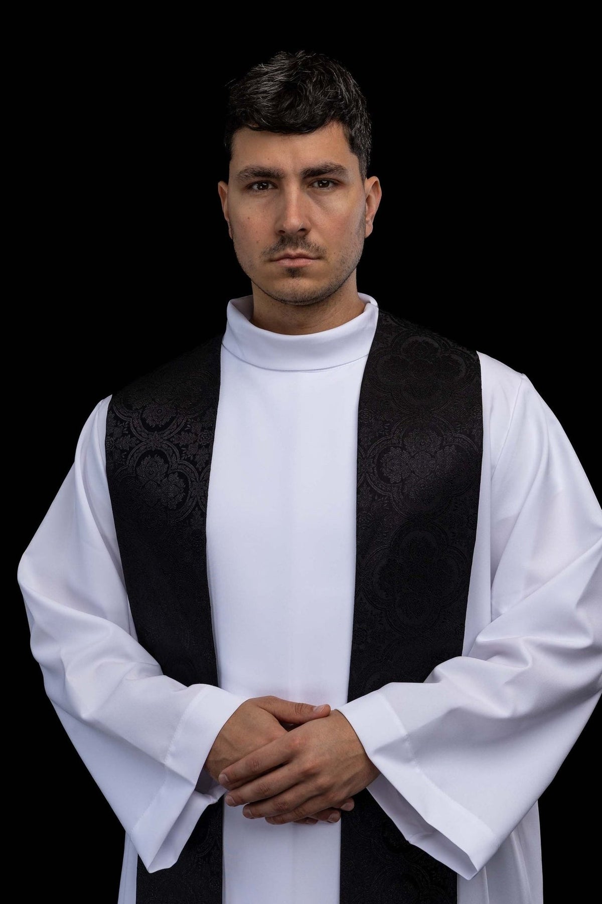 Black priest stole worn close-up showing subtle jacquard pattern