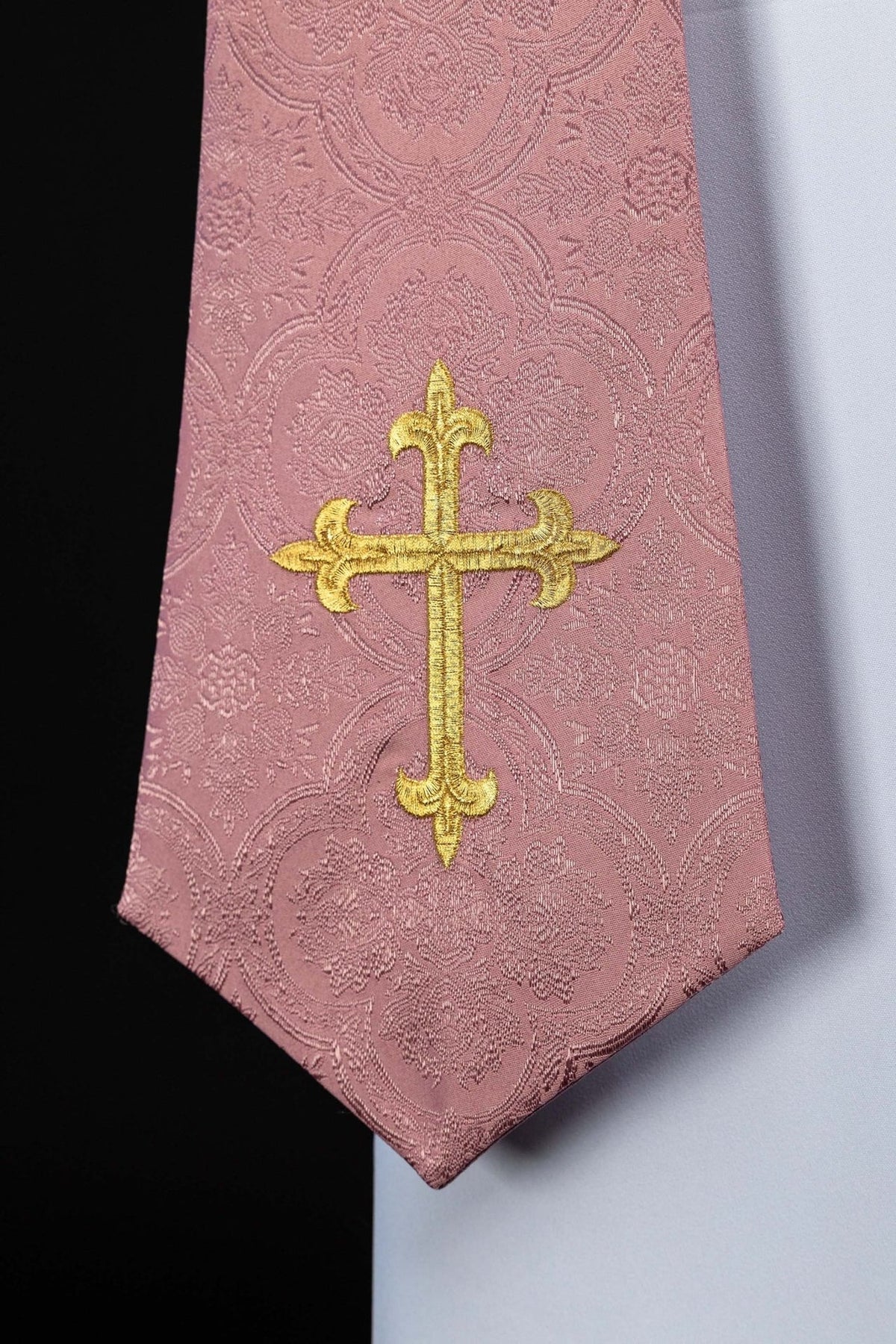 Rose stole close-up with gold embroidered cross and jacquard floral motifs