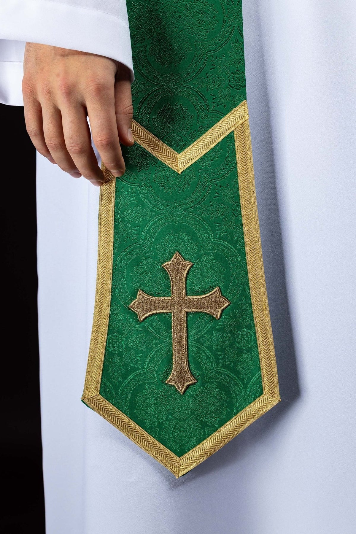 Green embroidered stole close-up with gold cross and chevron trim