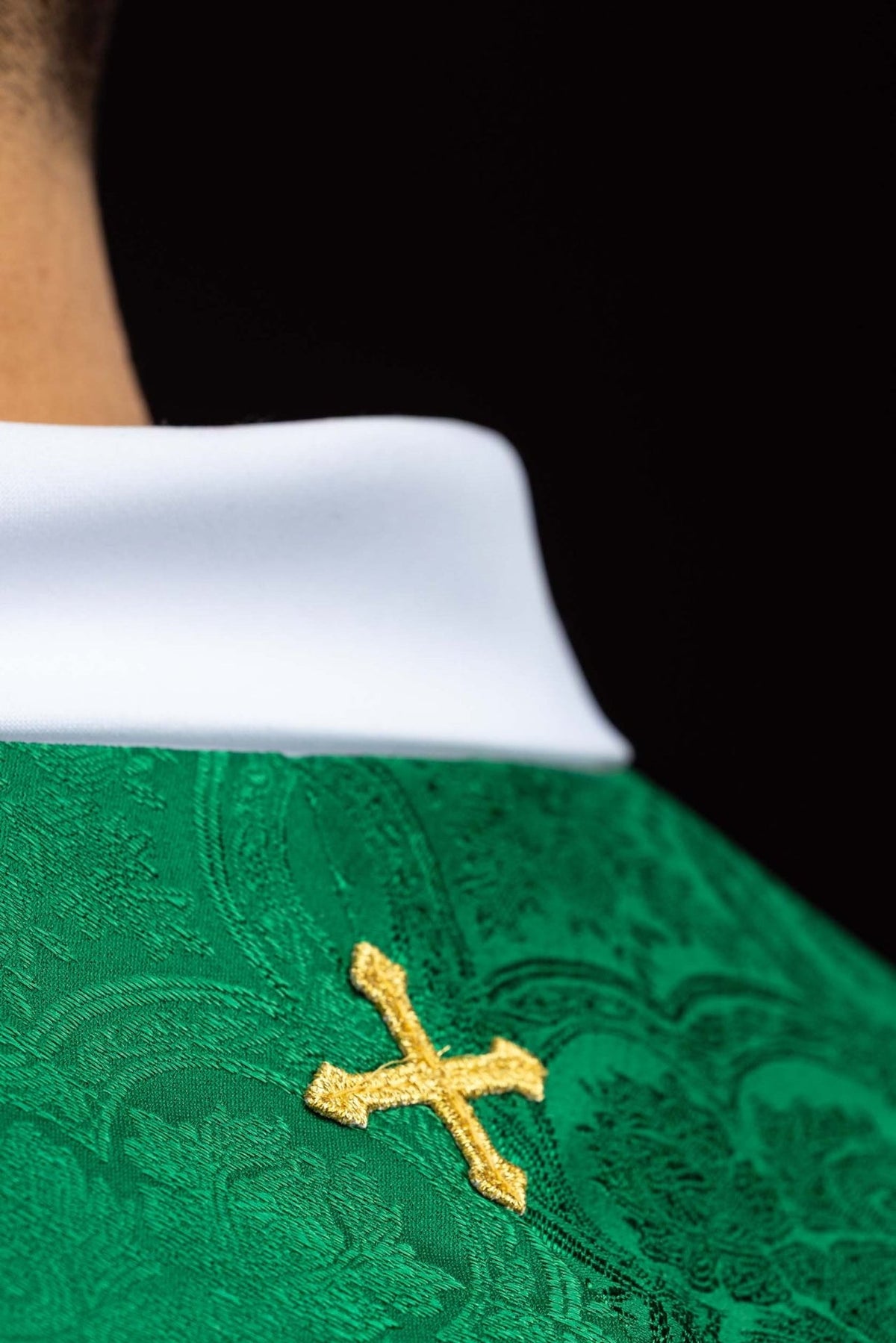 Green jacquard stole close-up with gold embroidered cross motif