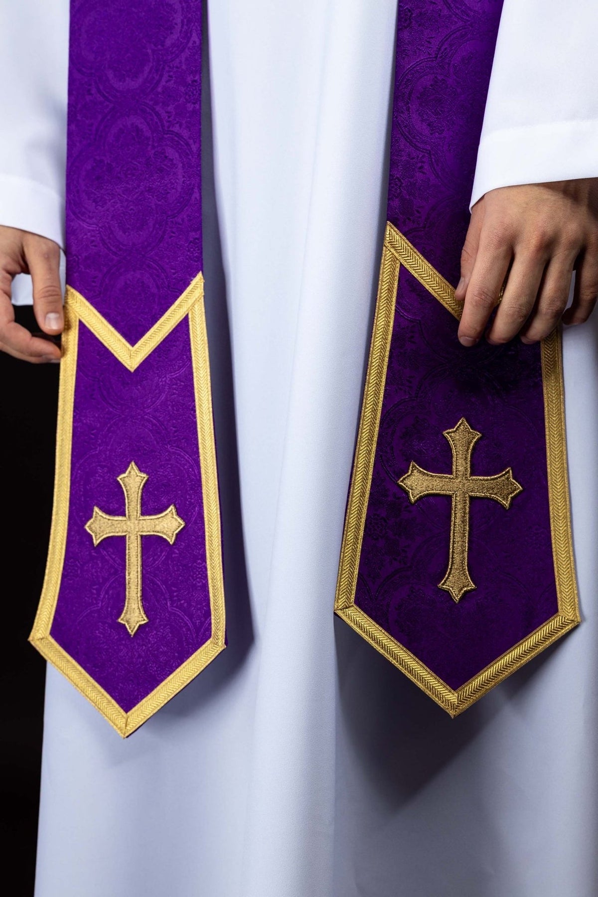 Purple priest stole worn front close-up with gold cross embroidery
