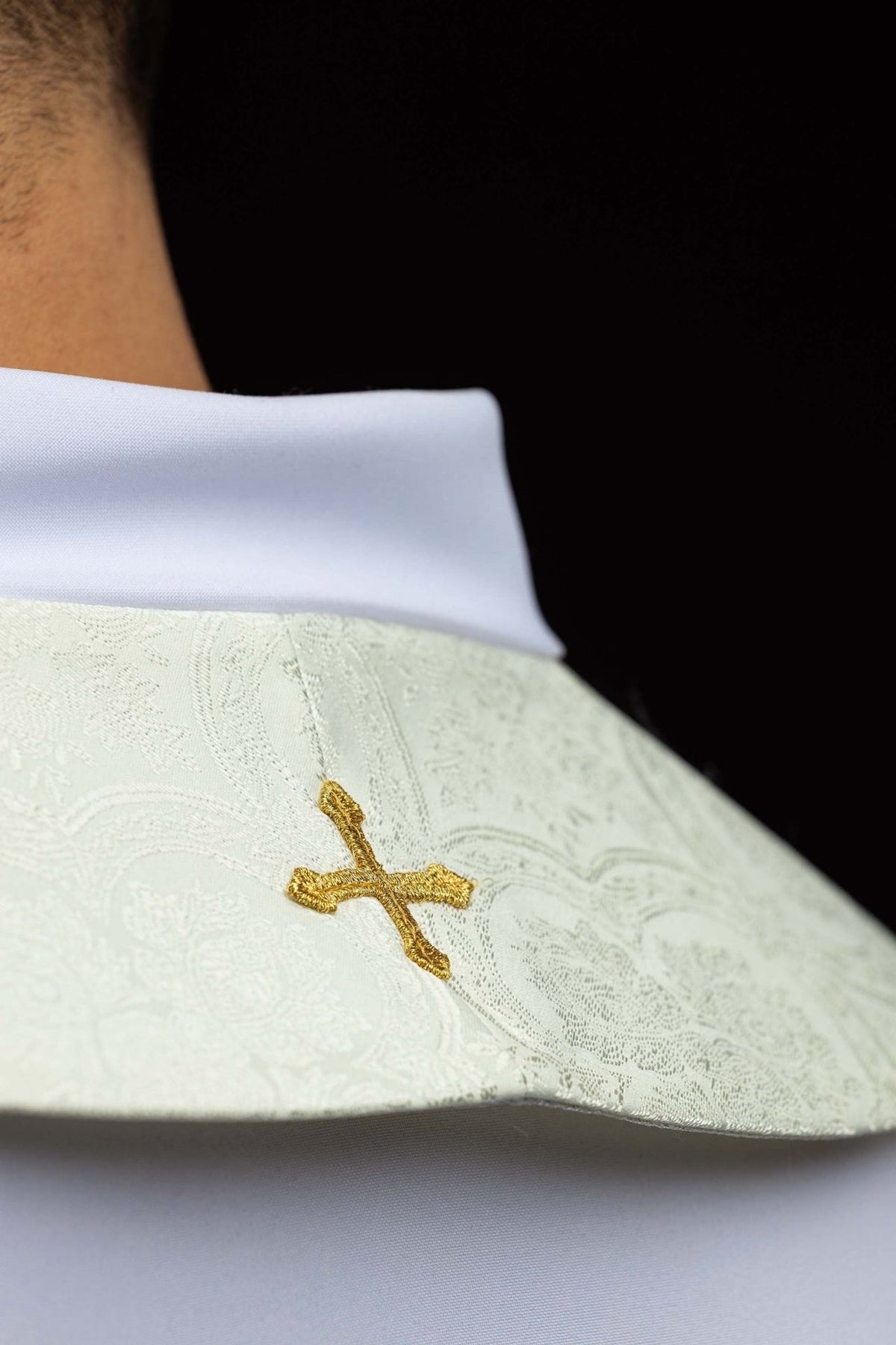 Ecru stole shoulder detail with small gold embroidered cross