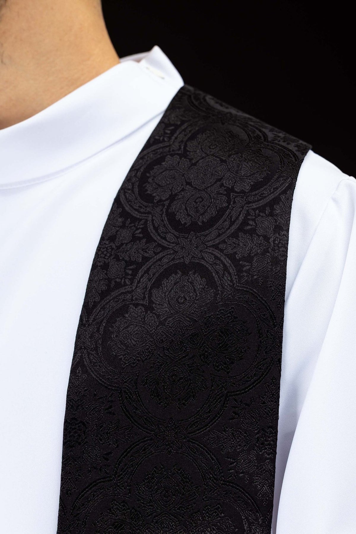 Black stole close-up showing jacquard fabric pattern