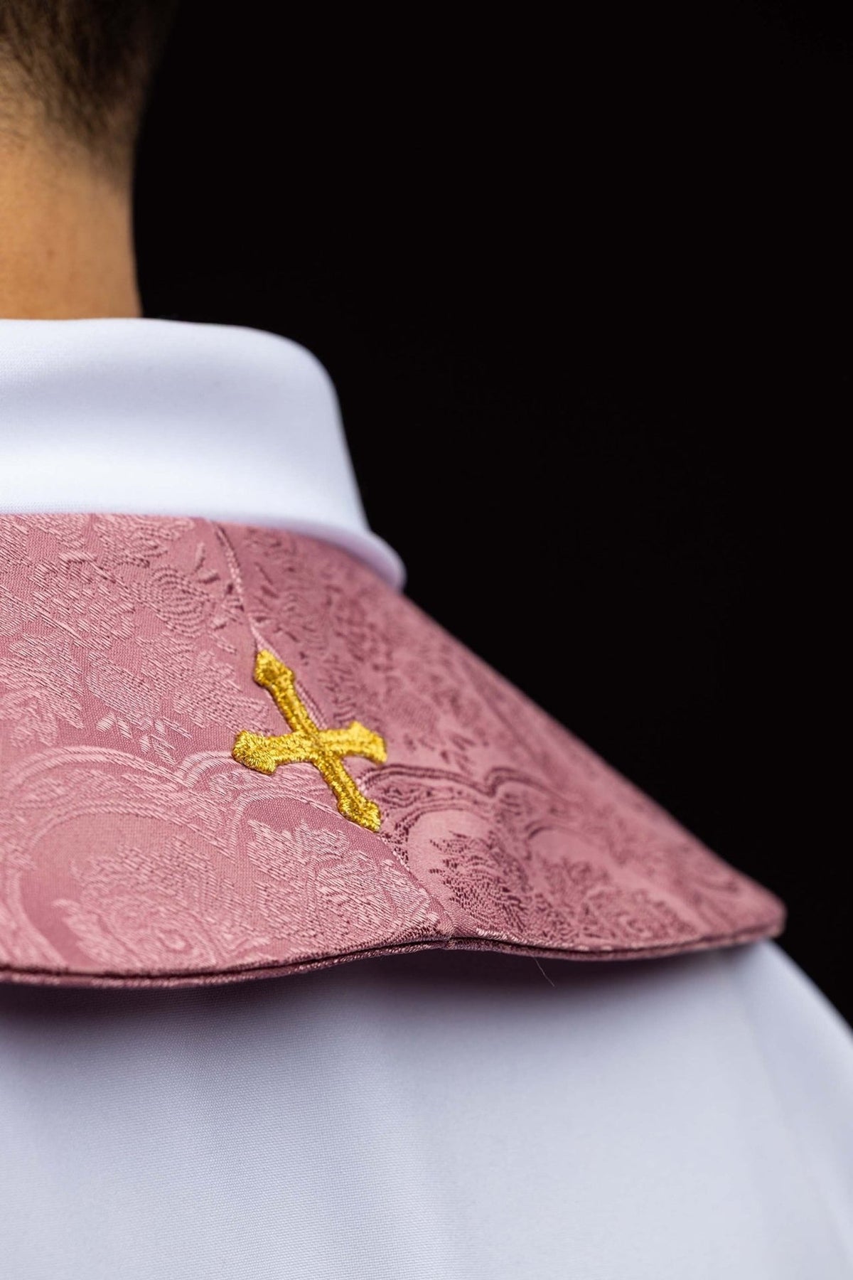 Rose stole side close-up showing jacquard fabric and small gold cross