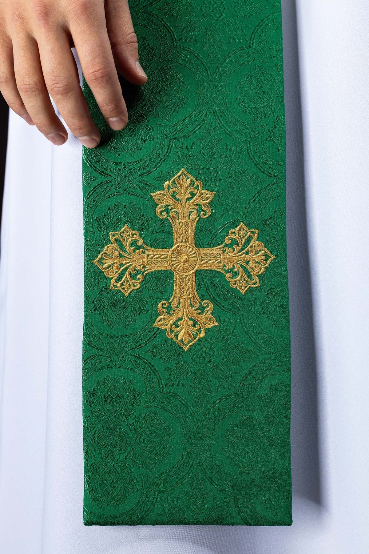 Green priest stole close-up with embroidered gold cross