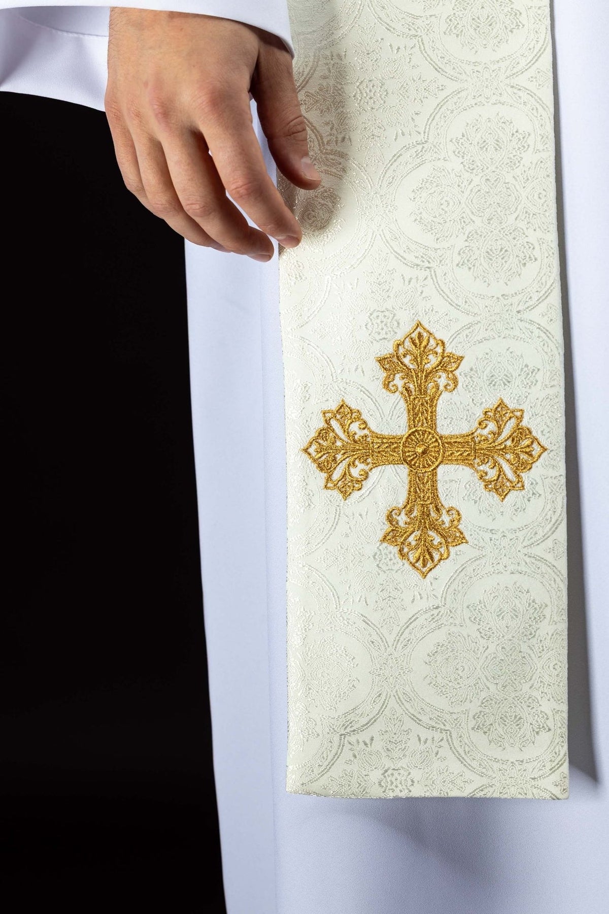 Ecru priest stole close-up with embroidered gold cross and jacquard pattern