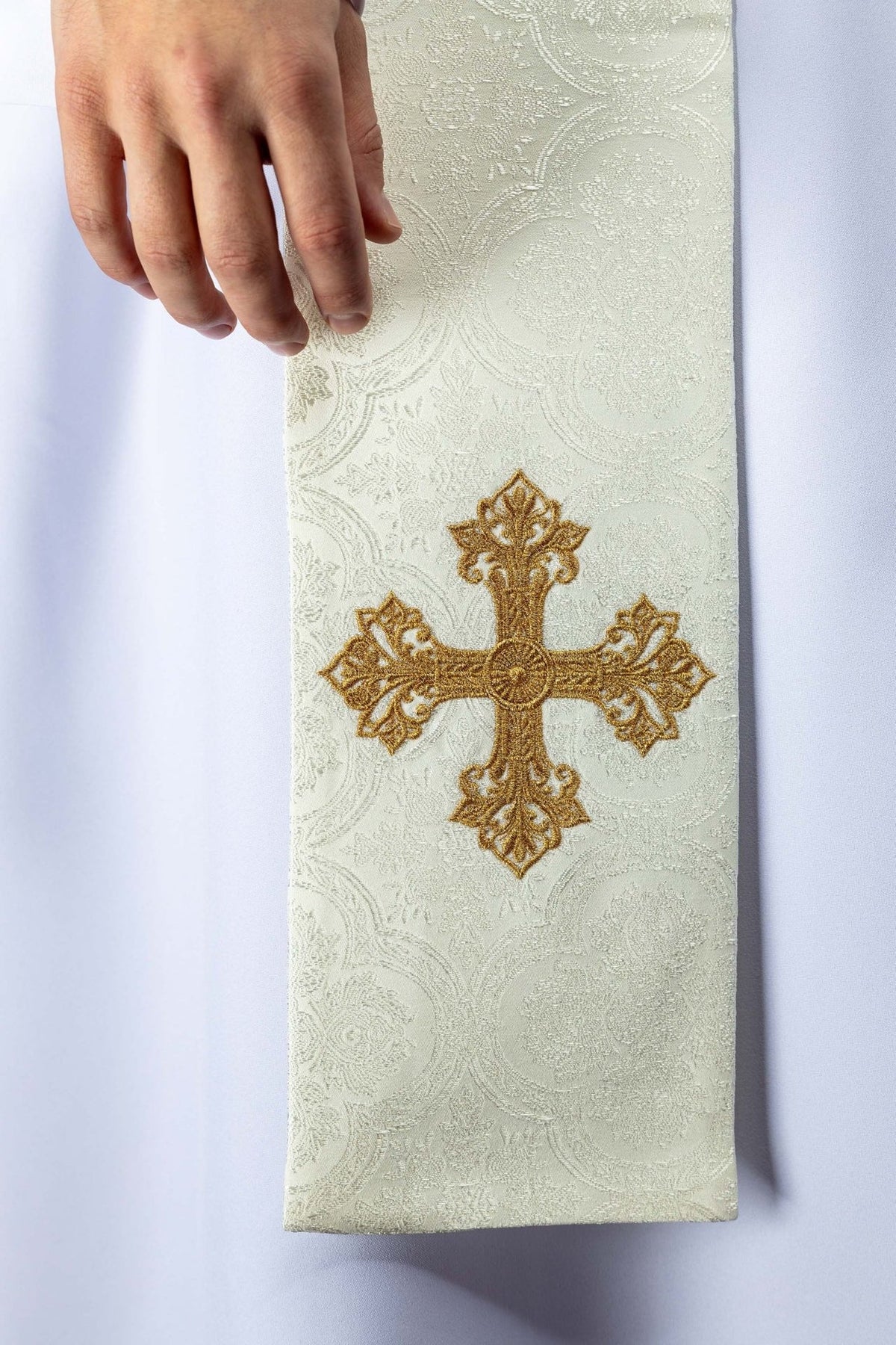 Ecru priest stole close-up with embroidered gold cross detail