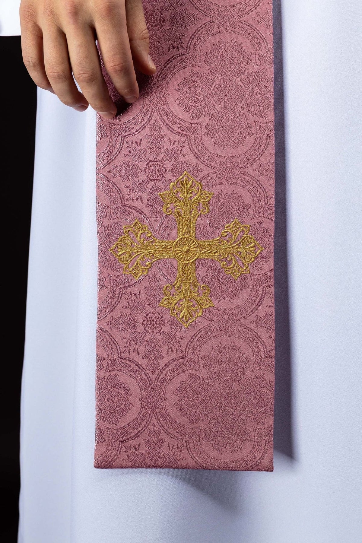 Rose priest stole close-up showing jacquard floral pattern and gold embroidered cross