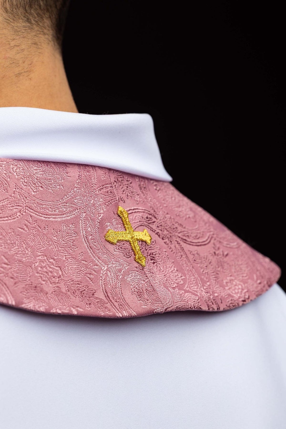 Rose stole collar detail with a small gold embroidered cross on jacquard fabric