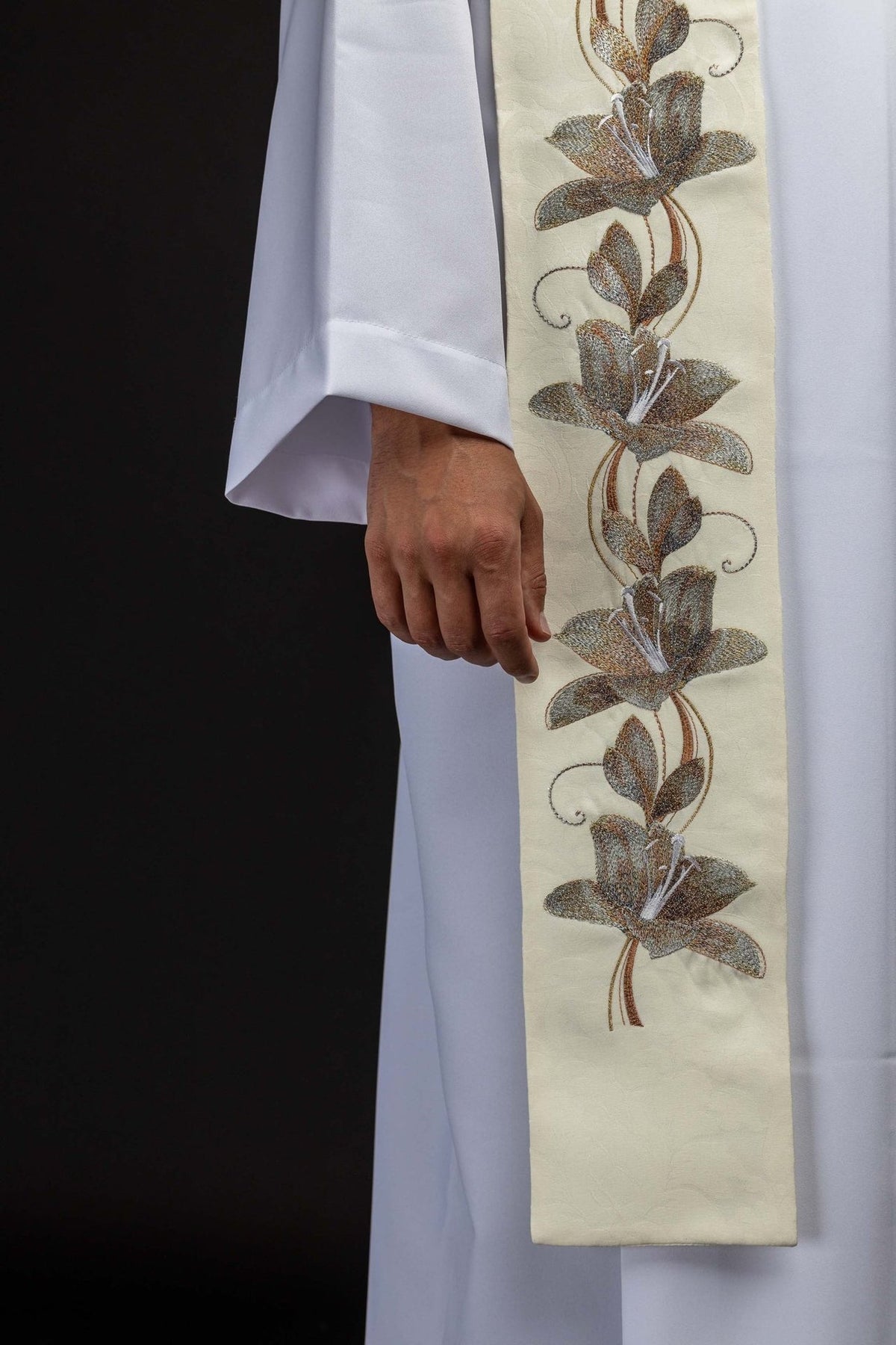 Stole detail showing gold and brown floral embroidery on ecru fabric