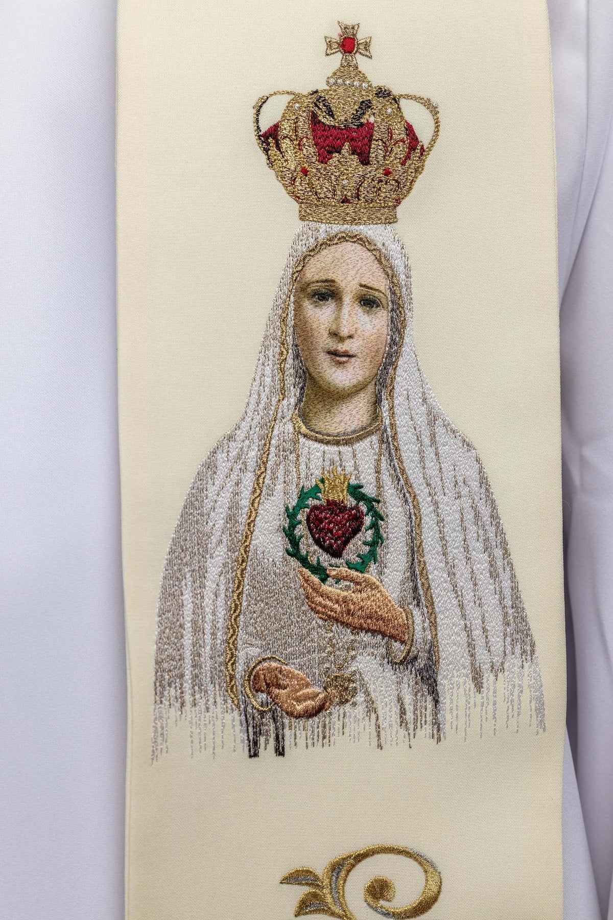 Embroidered stole close-up showing the Our Lady image with a crown and Sacred Heart